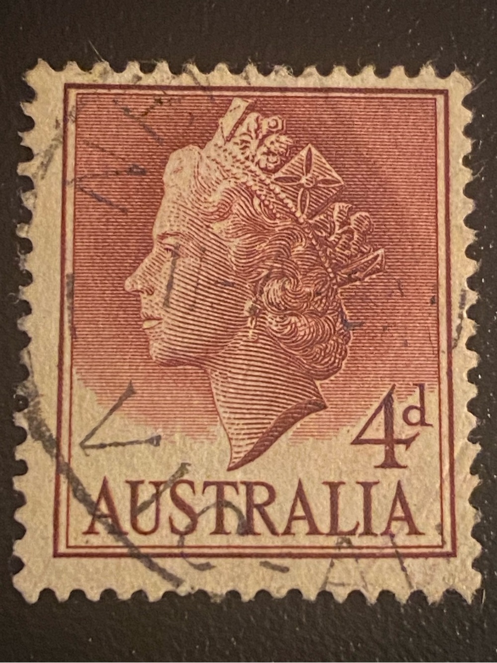 1957 Australian postage stamp featuring a portrait of Queen Elizabeth II.